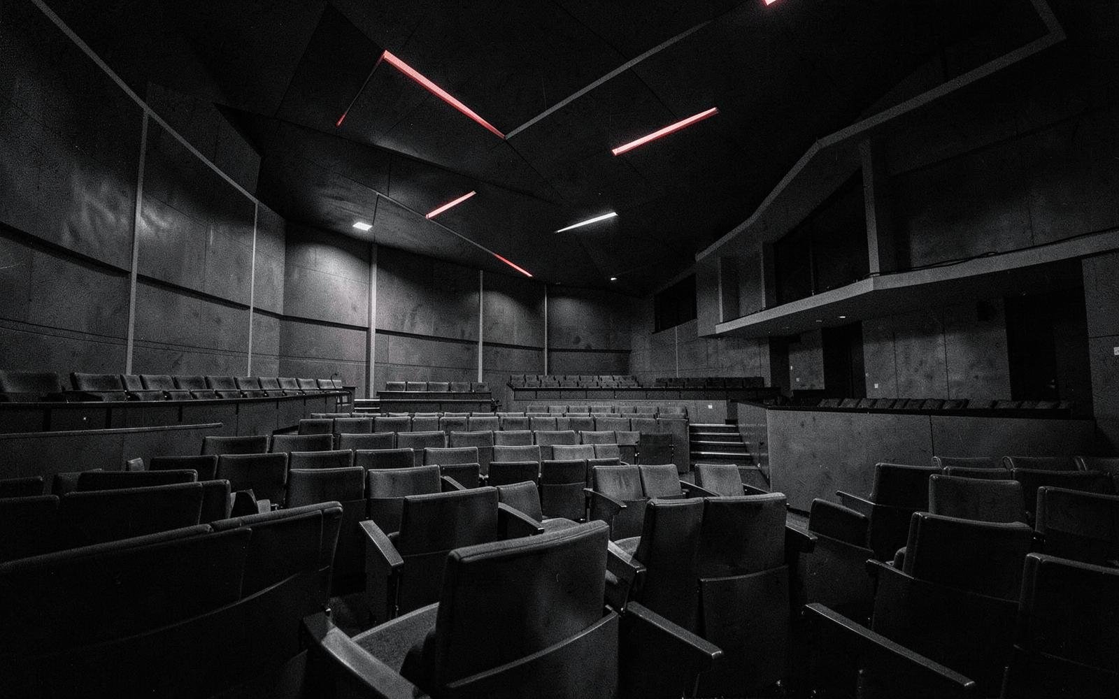 Dark auditorium interior with red light accents